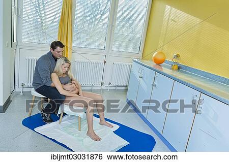 "Man and woman in the delivery room during childbirth, the woman is sitting on a birth stool during labour, Germany, Europe" View Large Photo Image Stock Photograph - "Man and woman in the delivery room during childbirth, the woman is sitting on a birth stool during labour, Germany, Europe". Fotosearch