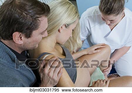"Man and woman in the delivery room during childbirth, the woman is sitting on a birth stool during labour and is being supported by her midwife, Germany, Europe" View Large Photo Image Stock Photography - "Man and woman in the delivery room during childbirth, the woman is sitting on a birth stool during labour and is being supported by her midwife, Germany, Europe". Fotosearch