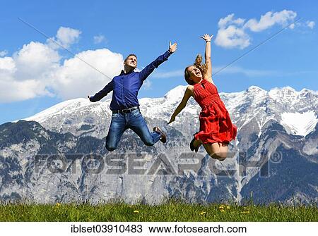 "Man and woman jumping on a meadow, in the spring, mountains at the back, Tyrol, Austria, Europe" View Large Photo Image Stock Image - "Man and woman jumping on a meadow, in the spring, mountains at the back, Tyrol, Austria, Europe". Fotosearch