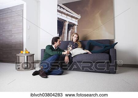 Man and woman on a couch in a hotel room View Large Photo Image Stock Image - Man and woman on a couch in a hotel room. Fotosearch