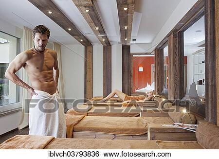 Man and woman relaxing in the relaxation area of a sauna View Large Photo Image Stock Photograph - Man and woman relaxing in the relaxation area of a sauna. Fotosearch