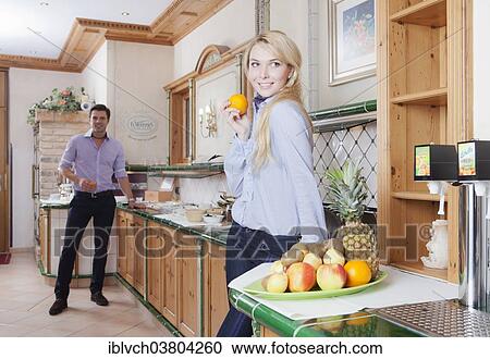 Stock Image - Man and woman standing at the breakfast buffet of a hotel. Fotosearch