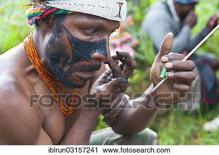 "Man applying make-up for the traditional Sing Sing gathering in the highlands, Paya, Papua New Guinea, Oceania" View Large Photo Image Stock Image - "Man applying make-up for the traditional Sing Sing gathering in the highlands, Paya, Papua New Guinea, Oceania". Fotosearch