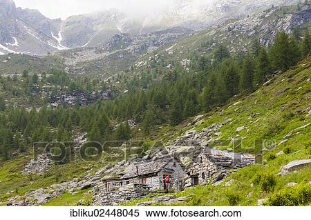 "Man arriving at a few mountain huts while hiking, Bavona Valley, Valle Maggia, Ticino, Switzerland, Europe" View Large Photo Image Stock Photography - "Man arriving at a few mountain huts while hiking, Bavona Valley, Valle Maggia, Ticino, Switzerland, Europe". Fotosearch