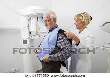 "Man being prepared for an X-ray of his teeth, wearing a lead vest for protection from radiation, Germany, Europe" View Large Photo Image Stock Image - "Man being prepared for an X-ray of his teeth, wearing a lead vest for protection from radiation, Germany, Europe". Fotosearch