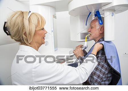 "Man being prepared for an X-ray of his teeth, wearing a lead vest for protection from radiation, Germany, Europe" View Large Photo Image Stock Photography - "Man being prepared for an X-ray of his teeth, wearing a lead vest for protection from radiation, Germany, Europe". Fotosearch