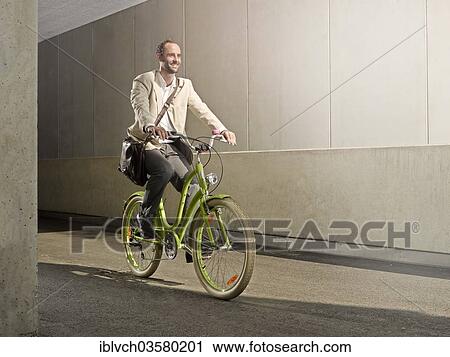 "Man carrying a bag over his shoulder while riding a bicycle in the city, Innsbruck, Tyrol, Austria, Europe" View Large Photo Image Stock Image - "Man carrying a bag over his shoulder while riding a bicycle in the city, Innsbruck, Tyrol, Austria, Europe". Fotosearch