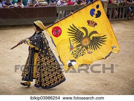 "Man carrying a flag from the Eagle or Aquila contrade, historical parade before the Palio di Siena horse race, Siena, Tuscany, Italy, Europe" View Large Photo Image Picture - "Man carrying a flag from the Eagle or Aquila contrade, historical parade before the Palio di Siena horse race, Siena, Tuscany, Italy, Europe". Fotosearch