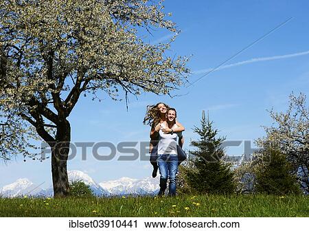 "Man carrying a woman, smiling, in front of a flowering tree in the spring, Tyrol, Austria, Europe" View Large Photo Image Stock Image - "Man carrying a woman, smiling, in front of a flowering tree in the spring, Tyrol, Austria, Europe". Fotosearch