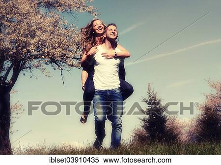 "Man carrying a woman, smiling, in front of a flowering tree in the spring, Tyrol, Austria, Europe" View Large Photo Image Stock Photography - "Man carrying a woman, smiling, in front of a flowering tree in the spring, Tyrol, Austria, Europe". Fotosearch