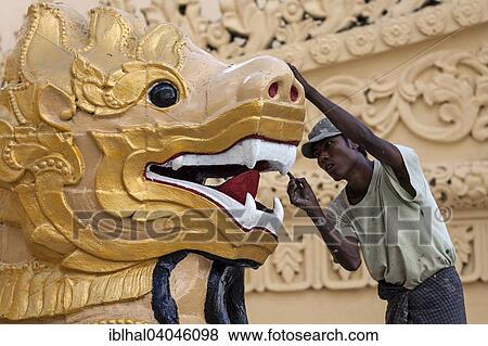 "Man carrying out restorations, golden lion's head, Maha Wizaya Pagoda, Yangon, Myanmar, Asia" View Large Photo Image Stock Photo - "Man carrying out restorations, golden lion's head, Maha Wizaya Pagoda, Yangon, Myanmar, Asia". Fotosearch