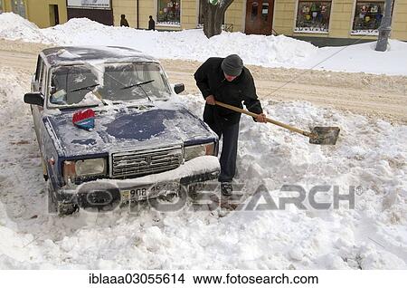 "Man clearing car from snow, Odessa, Odessa Oblast, Ukraine, Europe" View Large Photo Image Picture - "Man clearing car from snow, Odessa, Odessa Oblast, Ukraine, Europe". Fotosearch