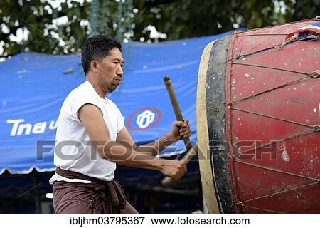 Stock Photo - "Man drumming outside the Wat Phra Si Rattana Mahathat Temple, Phitsanulok, Northern Thailand, Thailand, Asia". Fotosearch
