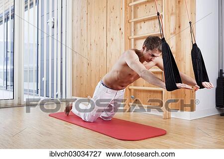 Stock Photo - Man during sling therapy. Fotosearch