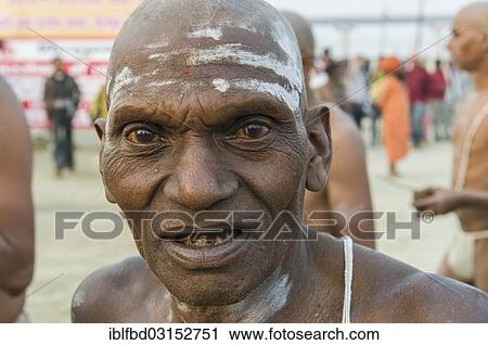 Stock Image - "Man during the initiation of new sadhus, during Kumbha Mela festival, Allahabad, Uttar Pradesh, India, Asia". Fotosearch