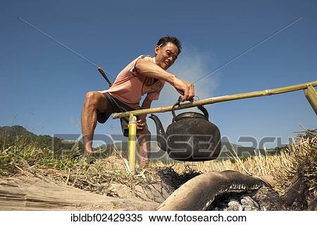 "Man from the Shan or Thai Yai ethnic minority, is boiling water in an iron kettle, Soppong or Pang Mapha area, Northern Thailand, Thailand, Asia" View Large Photo Image Stock Photography - "Man from the Shan or Thai Yai ethnic minority, is boiling water in an iron kettle, Soppong or Pang Mapha area, Northern Thailand, Thailand, Asia". Fotosearch