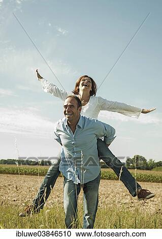 "Man giving a woman a piggyback ride, happy couple oudoors, Baden-Wurttemberg, Germany, Europe" View Large Photo Image Stock Image - "Man giving a woman a piggyback ride, happy couple oudoors, Baden-Wurttemberg, Germany, Europe". Fotosearch