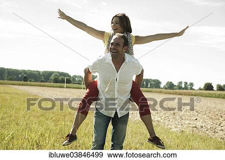 "Man giving a woman a piggyback ride, happy couple oudoors, Baden-Wurttemberg, Germany, Europe" View Large Photo Image Stock Photo - "Man giving a woman a piggyback ride, happy couple oudoors, Baden-Wurttemberg, Germany, Europe". Fotosearch