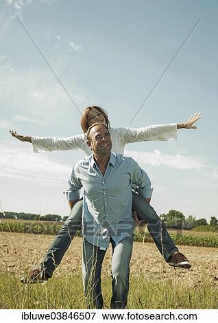 "Man giving a woman a piggyback ride, happy couple oudoors, Baden-Wurttemberg, Germany, Europe" View Large Photo Image Stock Photo - "Man giving a woman a piggyback ride, happy couple oudoors, Baden-Wurttemberg, Germany, Europe". Fotosearch