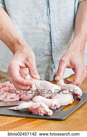 Man handling pieces of uncooked chicken in a kitchen View Large Photo Image Stock Image - Man handling pieces of uncooked chicken in a kitchen. Fotosearch