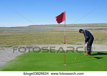 "Man hitting a golf ball on the northernmost golf course in the world, Victoria Island, formerly Holman Island, village of Ulukhaktok, Northwest Territories, Canada, North America" View Large Photo Image Picture - "Man hitting a golf ball on the northernmost golf course in the world, Victoria Island, formerly Holman Island, village of Ulukhaktok, Northwest Territories, Canada, North America". Fotosearch