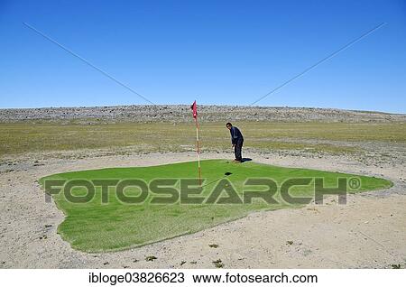 "Man hitting a golf ball on the northernmost golf course in the world, Victoria Island, formerly Holman Island, village of Ulukhaktok, Northwest Territories, Canada, North America" View Large Photo Image Stock Image - "Man hitting a golf ball on the northernmost golf course in the world, Victoria Island, formerly Holman Island, village of Ulukhaktok, Northwest Territories, Canada, North America". Fotosearch