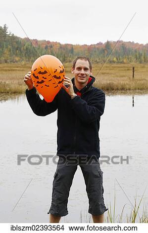 "Man holding a Halloween balloon, New York, USA" View Large Photo Image Picture - "Man holding a Halloween balloon, New York, USA". Fotosearch