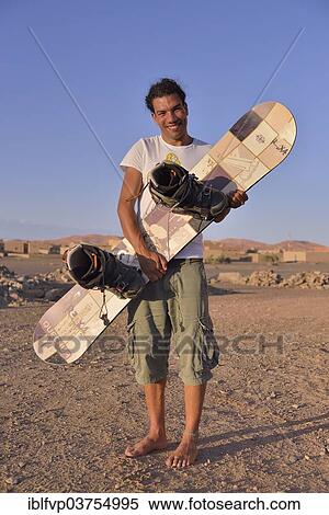 "Man holding a sandboard, sandboarder, Sahara, Merzouga, Meknes-Tafilalet region, Morocco, Africa" View Large Photo Image Stock Photography - "Man holding a sandboard, sandboarder, Sahara, Merzouga, Meknes-Tafilalet region, Morocco, Africa". Fotosearch
