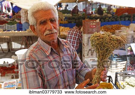 "Man holding herbs, farmer's market, Manavgat, Antalya Province, Turkey, Asia" View Large Photo Image Stock Image - "Man holding herbs, farmer's market, Manavgat, Antalya Province, Turkey, Asia". Fotosearch