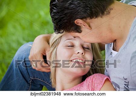 Man holding his wife tenderly in his arms View Large Photo Image Stock Photo - Man holding his wife tenderly in his arms. Fotosearch
