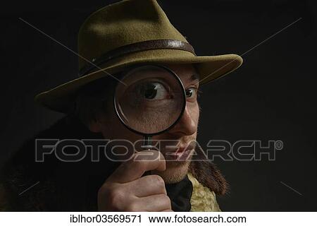 "Man holding magnifying glass in front of his eye, Switzerland, Europe" View Large Photo Image Stock Image - "Man holding magnifying glass in front of his eye, Switzerland, Europe". Fotosearch