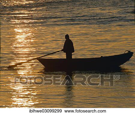 "Man in a boat at sunset, Museumshafen Neumuhlen, Hamburg, Hamburg, Germany, Europe" View Large Photo Image Stock Photo - "Man in a boat at sunset, Museumshafen Neumuhlen, Hamburg, Hamburg, Germany, Europe". Fotosearch