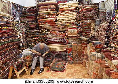 Stock Photography - "Man in a carpet dealer's store, Kemeralti, Izmir, Izmir Province, Aegean Region, Turkey, Asia". Fotosearch