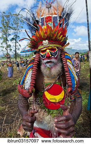 "Man in a colourfully decorated costume with face paint at the traditional sing-sing gathering, Hochland, Mount Hagen, Western Highlands Province, Papua New Guinea, Oceania" View Large Photo Image Stock Photo - "Man in a colourfully decorated costume with face paint at the traditional sing-sing gathering, Hochland, Mount Hagen, Western Highlands Province, Papua New Guinea, Oceania". Fotosearch
