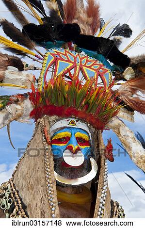 "Man in a colourfully decorated costume with face paint at the traditional sing-sing gathering, Hochland, Mount Hagen, Western Highlands Province, Papua New Guinea, Oceania" View Large Photo Image Stock Photo - "Man in a colourfully decorated costume with face paint at the traditional sing-sing gathering, Hochland, Mount Hagen, Western Highlands Province, Papua New Guinea, Oceania". Fotosearch