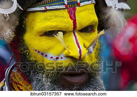 "Man in a colourfully decorated costume with face paint is celebrating at the traditional Sing Sing gathering in the highlands, Paya, Papua New Guinea, Oceania" View Large Photo Image Stock Photo - "Man in a colourfully decorated costume with face paint is celebrating at the traditional Sing Sing gathering in the highlands, Paya, Papua New Guinea, Oceania". Fotosearch