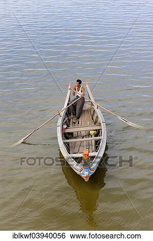 "Man in a traditional rowing boat on the Taungthaman Lake, Amarapura, Mandalay Division, Myanmar, Asia" View Large Photo Image Stock Photograph - "Man in a traditional rowing boat on the Taungthaman Lake, Amarapura, Mandalay Division, Myanmar, Asia". Fotosearch