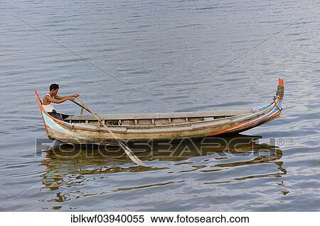 "Man in a traditional rowing boat on the Taungthaman Lake, Amarapura, Mandalay Division, Myanmar, Asia" View Large Photo Image Stock Photography - "Man in a traditional rowing boat on the Taungthaman Lake, Amarapura, Mandalay Division, Myanmar, Asia". Fotosearch