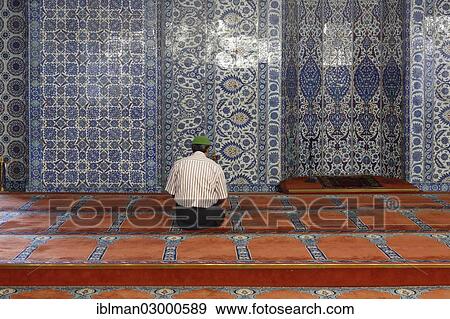 Stock Photo - "Man in prayer in front of a wall with Iznik faience tiles, Ruestem Pasha Mosque, Eminonu, Istanbul, European side, Istanbul Province, Turkey, European side, Europe". Fotosearch