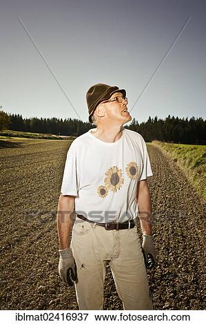 Man in the field View Large Photo Image Stock Photo - Man in the field. Fotosearch