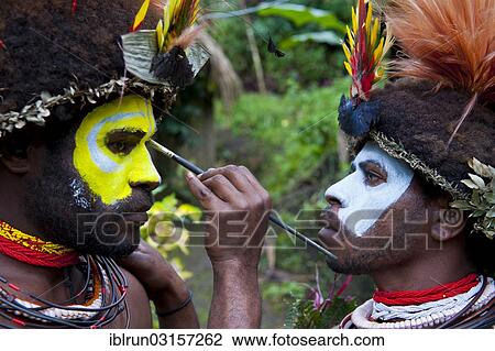 Stock Image - "Man is made up for the traditional Sing Sing gathering in the highlands, Paya, Papua New Guinea, Oceania". Fotosearch