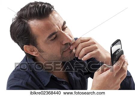Man looking at a mobile phone View Large Photo Image Stock Image - Man looking at a mobile phone. Fotosearch