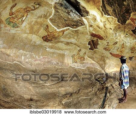"Man looking at the """"cloud girls"""" petroglyphs at Lion Rock, frescoes, murals, UNESCO World Heritage Site, Sigiriya, Sigirija, Zentralprovinz, Sri Lanka, Asia" View Large Photo Image Stock Photo - "Man looking at the """"cloud girls"""" petroglyphs at Lion Rock, frescoes, murals, UNESCO World Heritage Site, Sigiriya, Sigirija, Zentralprovinz, Sri Lanka, Asia". Fotosearch