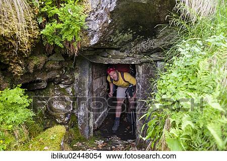"Man looking out of a rock cellar, origin of the Grotto, Val Calneggia, Bavona Valley, Valle Maggia, Ticino, Switzerland, Europe" View Large Photo Image Picture - "Man looking out of a rock cellar, origin of the Grotto, Val Calneggia, Bavona Valley, Valle Maggia, Ticino, Switzerland, Europe". Fotosearch