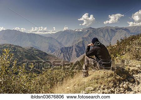 Stock Photograph - "Man looking over Andean scenery, Andes, Peru, South America". Fotosearch