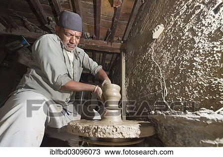 "Man making pottery by hand with simple equipment, Kathmandu Valley, Thimi, Kathmandu District, Bagmati Zone, Nepal, Asia" View Large Photo Image Stock Image - "Man making pottery by hand with simple equipment, Kathmandu Valley, Thimi, Kathmandu District, Bagmati Zone, Nepal, Asia". Fotosearch