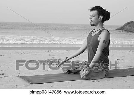 Stock Photograph - "Man meditating on the beach, India, Asia". Fotosearch