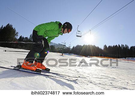 Stock Photo - "Man, mid-50s, skiing, Blomberg, Bad Toelz, Upper Bavaria, Bavaria, Germany, Europe". Fotosearch