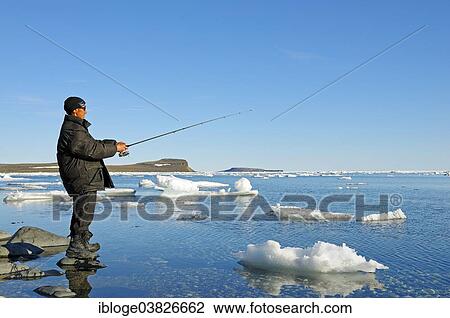 "Man of the Inuit people fishing on the banks of the Beaufort Sea, Arctic Ocean, Victoria Island, formerly Holman Island, village of Ulukhaktok, Northwest Territories, Canada, North America" View Large Photo Image Stock Image - "Man of the Inuit people fishing on the banks of the Beaufort Sea, Arctic Ocean, Victoria Island, formerly Holman Island, village of Ulukhaktok, Northwest Territories, Canada, North America". Fotosearch