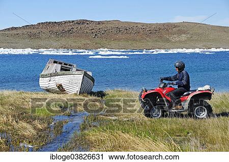 "Man of the Inuit people riding a quad bike, ATM, in the tundra to Victoria Island, formerly Holman Island, village of Ulukhaktok, Northwest Territories, Canada, North America" View Large Photo Image Stock Image - "Man of the Inuit people riding a quad bike, ATM, in the tundra to Victoria Island, formerly Holman Island, village of Ulukhaktok, Northwest Territories, Canada, North America". Fotosearch